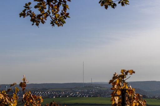 A distant view of a landscape with houses and fields during sunset