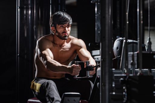 A fit athletic muscular Caucasian man working out at the gym