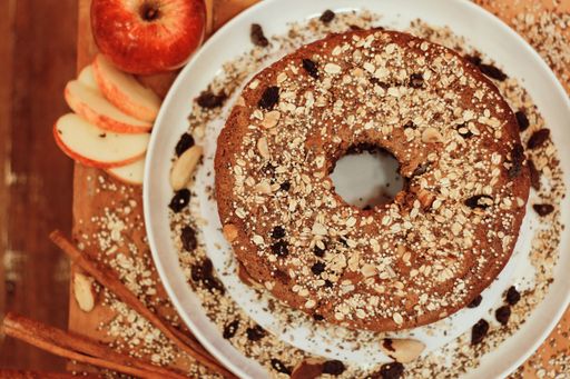 An overhead closeup of an oatmeal pie on a white plate with whole oatmeal sprinkled on top. Great for a culinary piece.