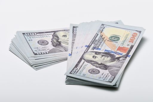 A closeup shot of one hundred dollar banknkotes isolated on a white background