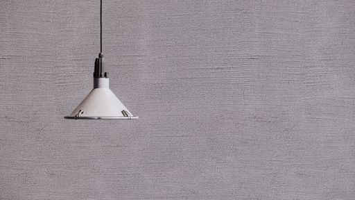 A hanging lamp against the gray wall