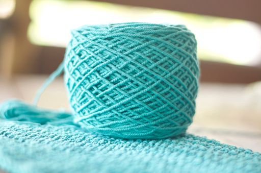 A closeup shot of a blue thread on the blue textile