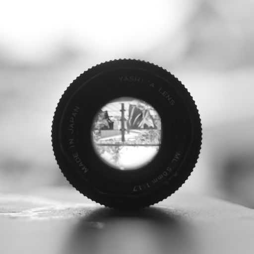 A grayscale closeup view of a camera lens