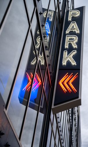 A low-angle shot of a park sign with lights