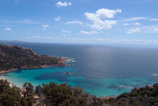 The cloudy blue sky over the sea captured from the coast in summer
