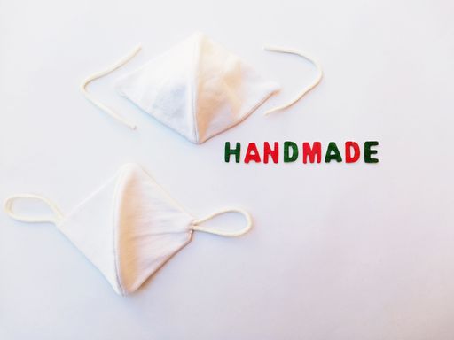 An overhead top view of handmade cotton masks against coronavirus on a white background