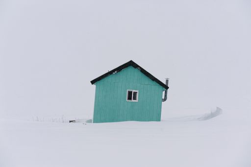 small cabin at Bering Sea coast in surrounded by drifting snow in Januar
