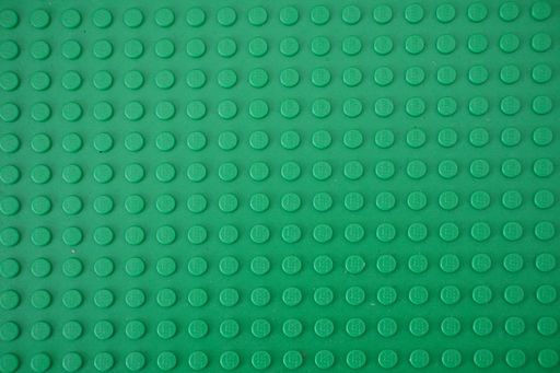 A green plastic Lego board