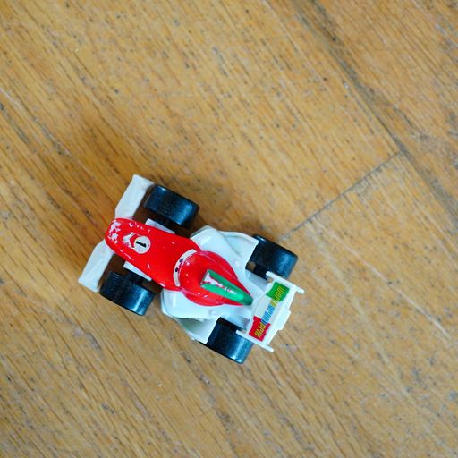 A closeup shot of a toy model cars from "Cars" cartoon on a wooden surface.