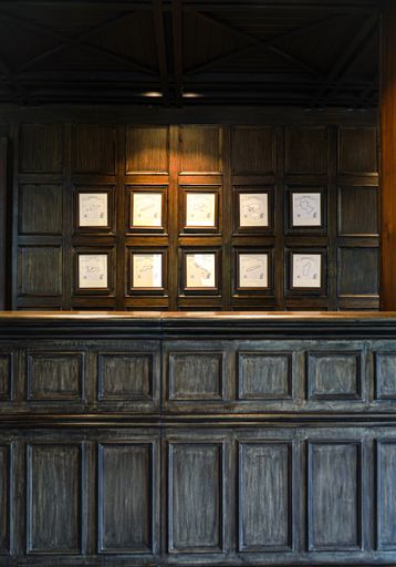 A vertical shot of a wooden reception desk in the hotel