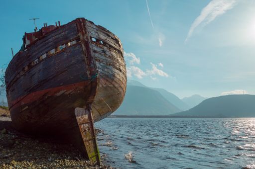 A low angle shot of Derelict fishing vessel with Ben Nevis in background