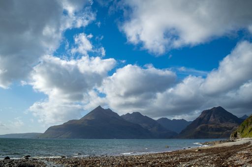 A beautiful scenery of rocky cliffs by the sea under a cloudy sky