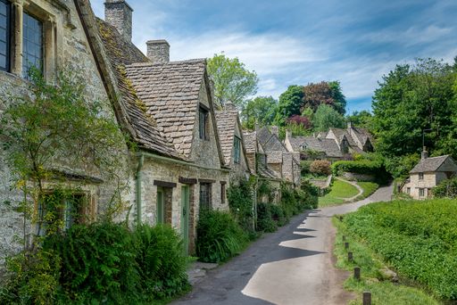 A beautiful horizontal shot of Arlington Row in Bibury with a lot of concrete houses