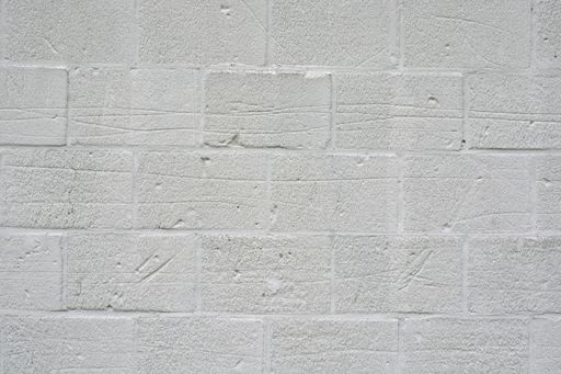 A closeup shot of a white concrete brick wall texture -perfect for background or wallpaper