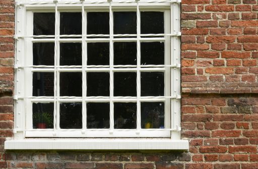 A closeup shot of the concrete brick wall with white framed window - perfect for background