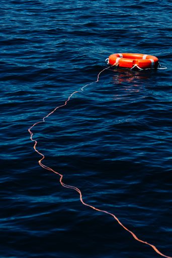 A vertical shot of a red lifebuoy on a bay of Algarve, Portugal