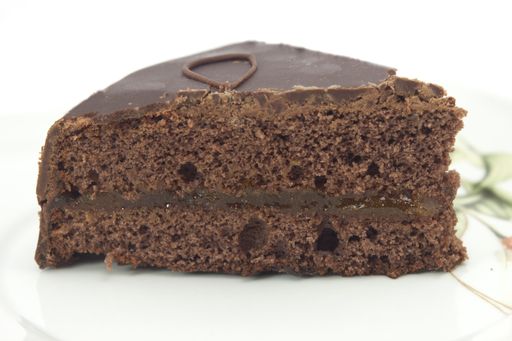 A high angle shot of a fresh and delicious chocolate Sacher cake on a white surface