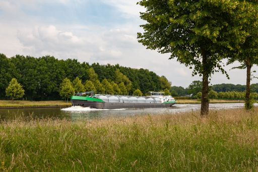 An inland transport vessel under a cloudy sky in the Netherlands