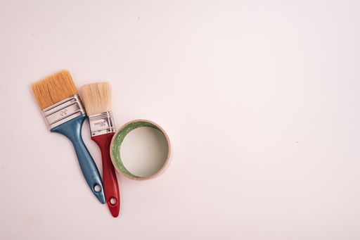 A high angle shot of two paint brushes isolated on a white background