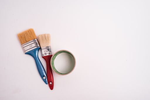 A closeup shot of two paintbrushes isolated on a white background