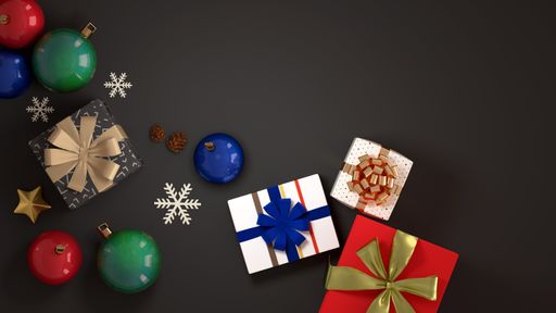A top view of Christmas gifts, balls and snowflakes isolated on a dark background