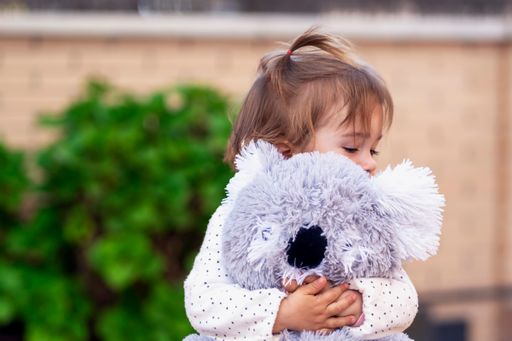 happy girl hugging her teddy