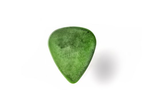 A closeup of an old green guitar pick on a white background