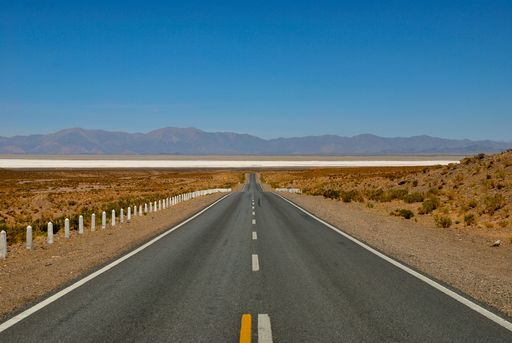 straight road towards salinas grandes high up in the andes, Jujuy, Salta, Argentina