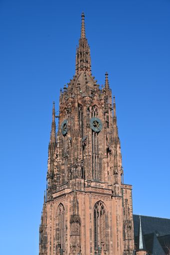 A vertical shot of Frankfurt Cathedral Tower against a blue sky in Germany