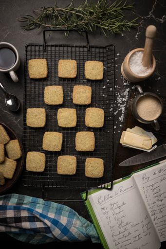 A top view of beautiful cookies, sugar, butter with cup of tea and small spoon