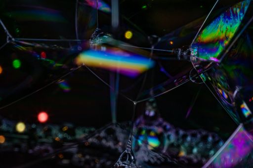 A closeup shot of soap bubbles with rainbow colors in it