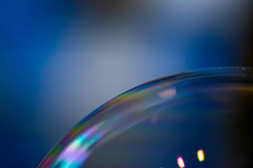 A closeup shot of soap bubbles with rainbow colors in it