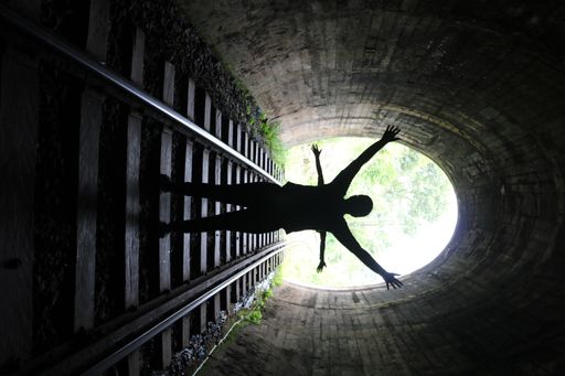 Two people under the Demodara railway tunnel in Sri Lanka