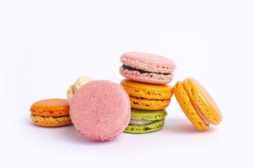 A closeup of colorful macaroons against a white background