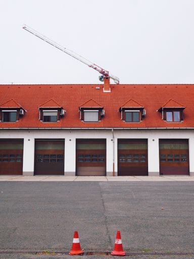 A vertical shot of a warehouse building with a red rooftop
