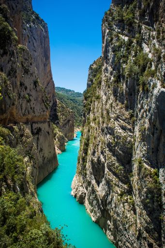 A vertical shot of a strait with blue water between beautiful rock formations. Can be a beautiful wallpaper