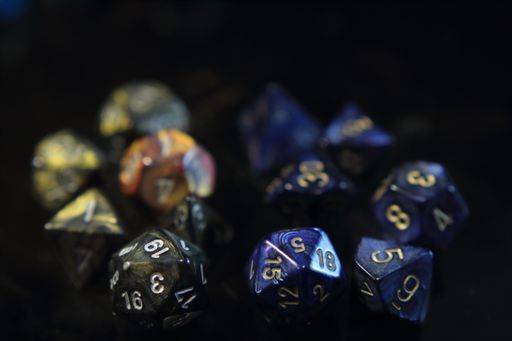 Blue metallic swirl dice with gold numbers and smoke dice with gold metallic swirls and silver numbers