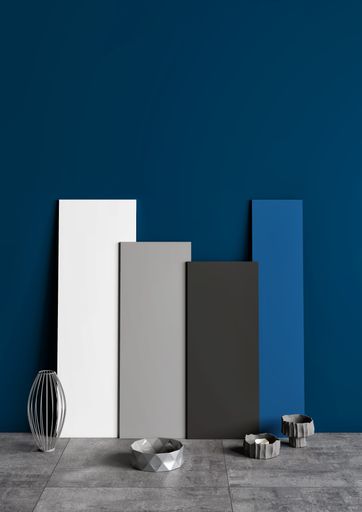 A vertical shot of board mockups on the background of a blue wall
