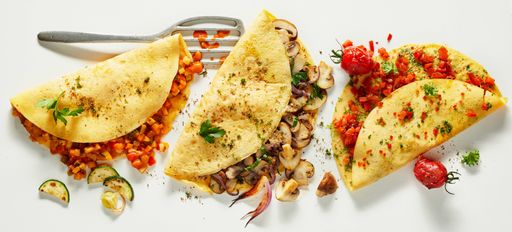 A Top view of assorted vegetarian omelets served  for a nutritious lunch ,on a white background
