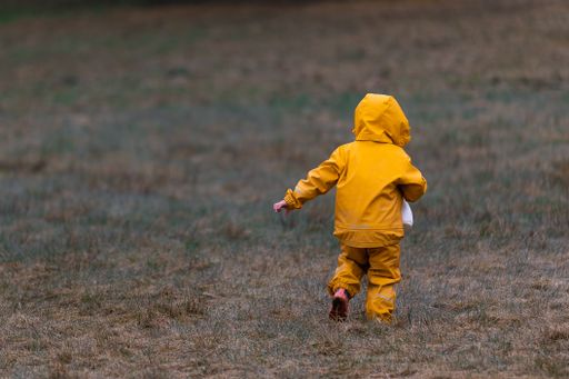 A closeup of a girl running in a field outside Karlshus