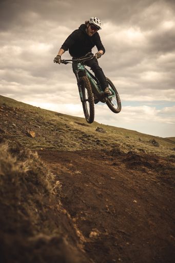 A vertical shot of a mountain biker
