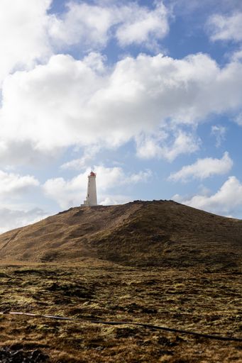 A vertical shot of the famous Reykjanes lighthouse in Iceland under a cloudy sky