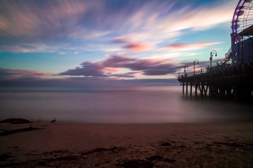 A bright purple pink sunset sky over Santa Monica pier in Los Angeles, USA