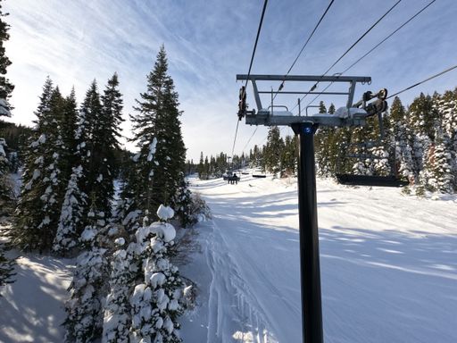 An aerial shot of the Lake Tahoe chair lift covered in snow after a large storm