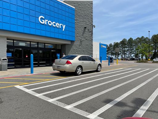 Grovetown, Ga USA - 04 20 22: Walmart retail store entrance people and cars