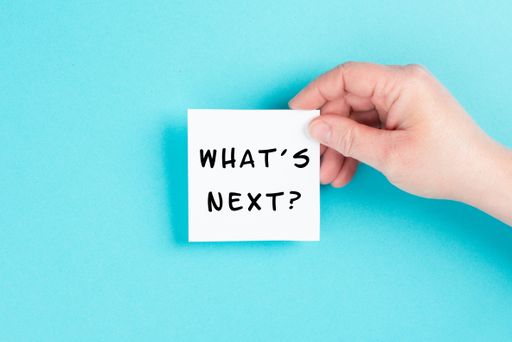 The phrase whats next is standing on a cloud shaped paper, having new goals and strategies, making plans for future