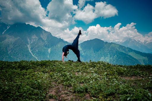 A young woman doing yoga exercises in a natural environment