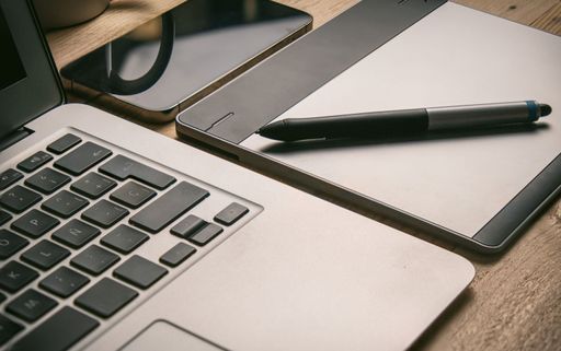 Graphic tablet and pencil on office desk. Tool design graphic