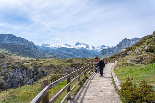 A back shot of a family walking on the path heading to the Buferrera mines in the Covadonga lakes. Asturias. Spain