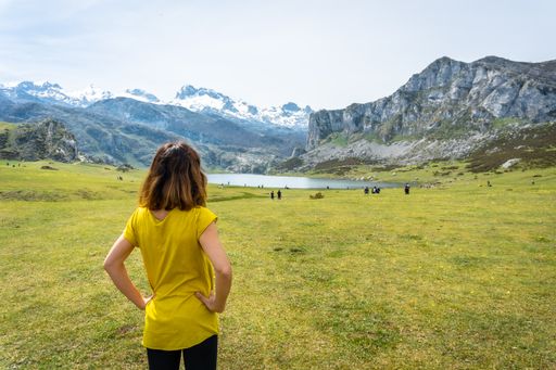 A back shot of a young woman visiting Lake Ercina in the Lakes of Covadonga. Asturias. Spain